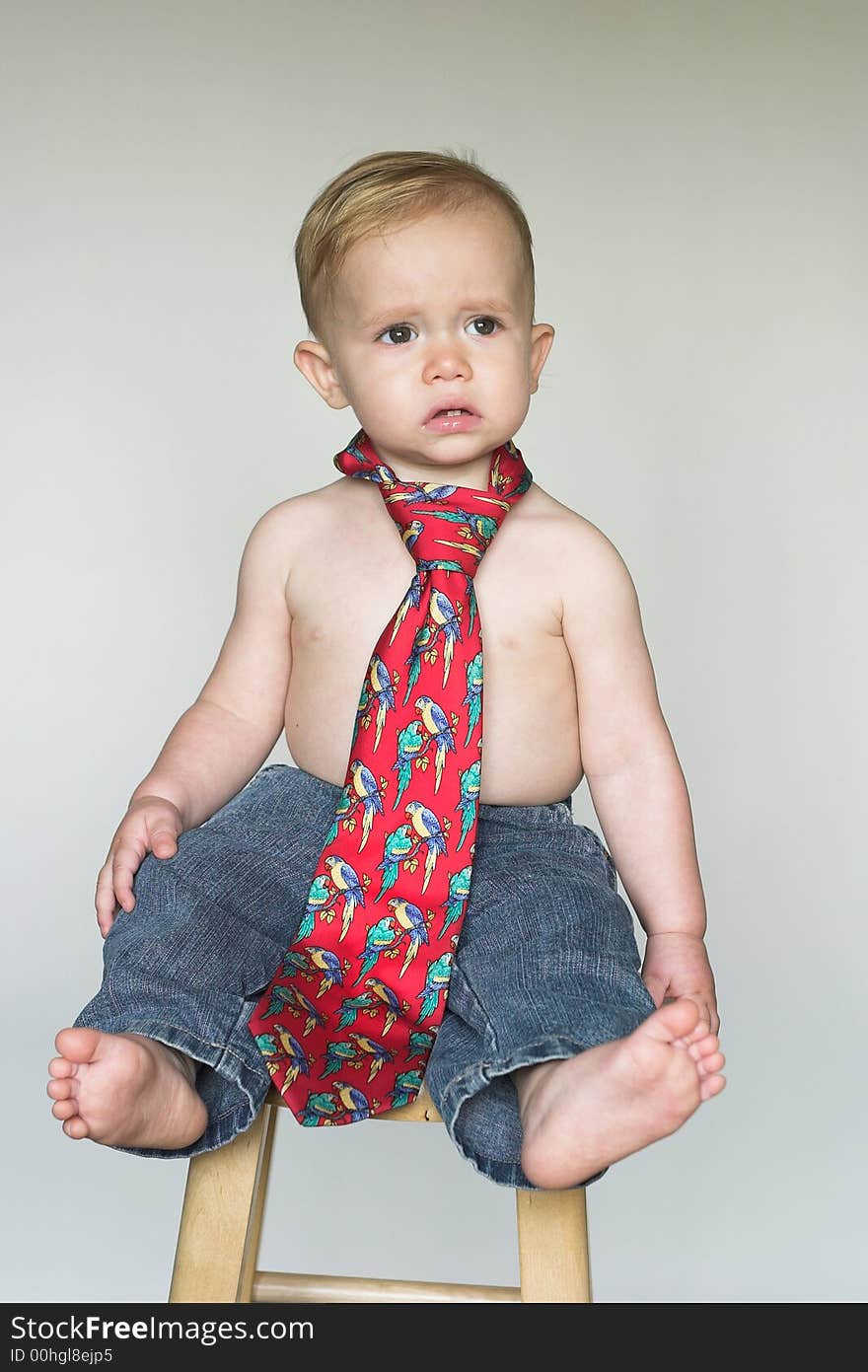 Image of cute toddler wearing jeans and a tie. Image of cute toddler wearing jeans and a tie