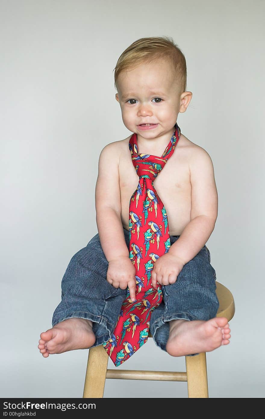 Image of cute toddler wearing jeans and a tie. Image of cute toddler wearing jeans and a tie