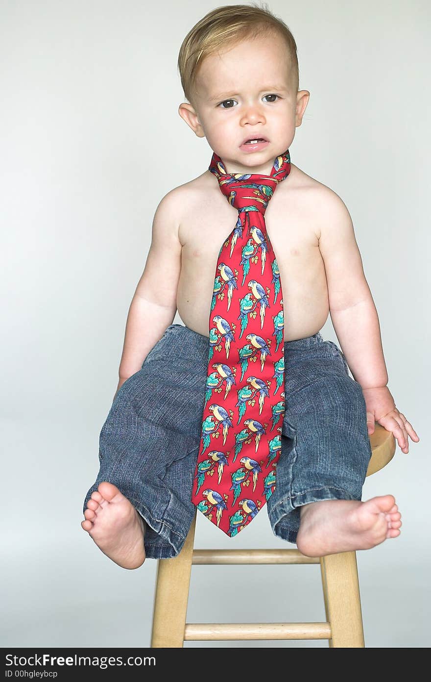 Image of cute toddler wearing jeans and a tie. Image of cute toddler wearing jeans and a tie