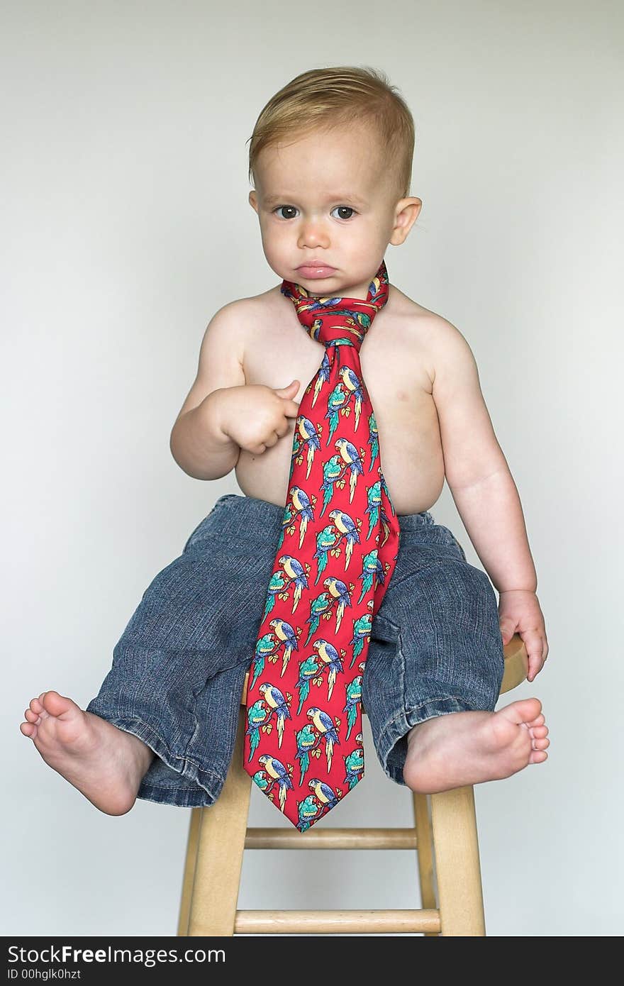 Image of cute toddler wearing jeans and a tie. Image of cute toddler wearing jeans and a tie