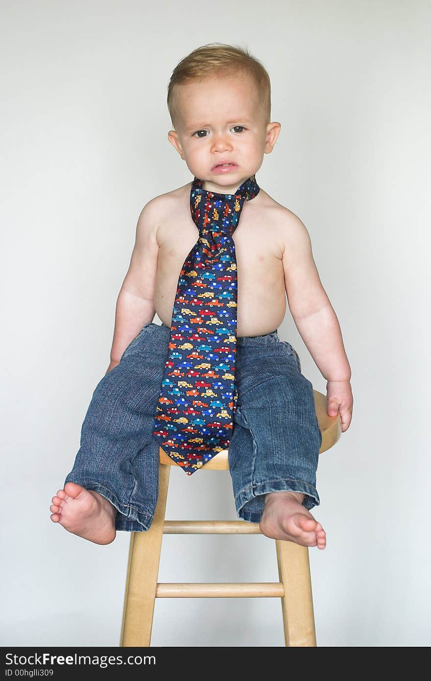 Image of cute toddler wearing jeans and a tie. Image of cute toddler wearing jeans and a tie