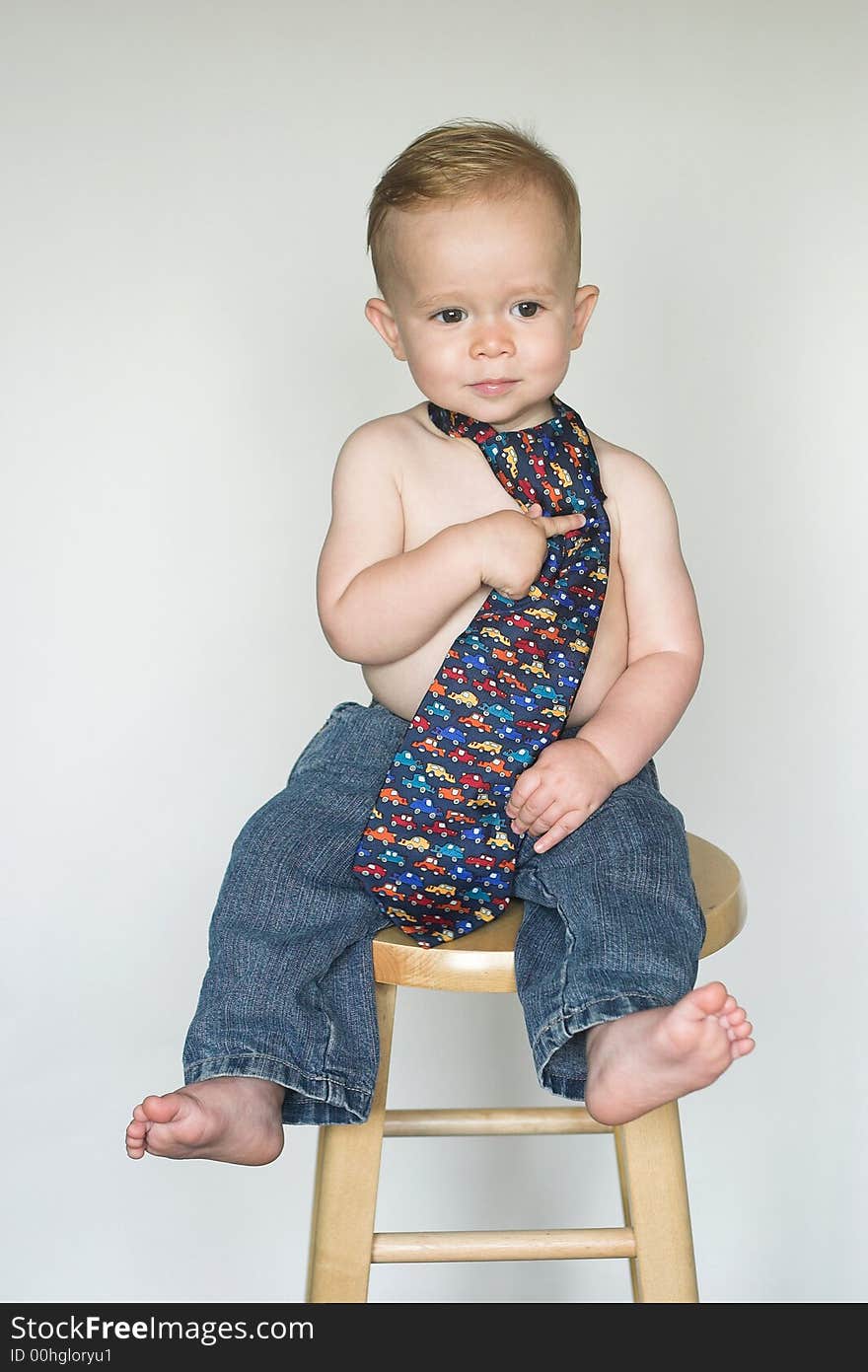 Image of cute toddler wearing jeans and a tie. Image of cute toddler wearing jeans and a tie