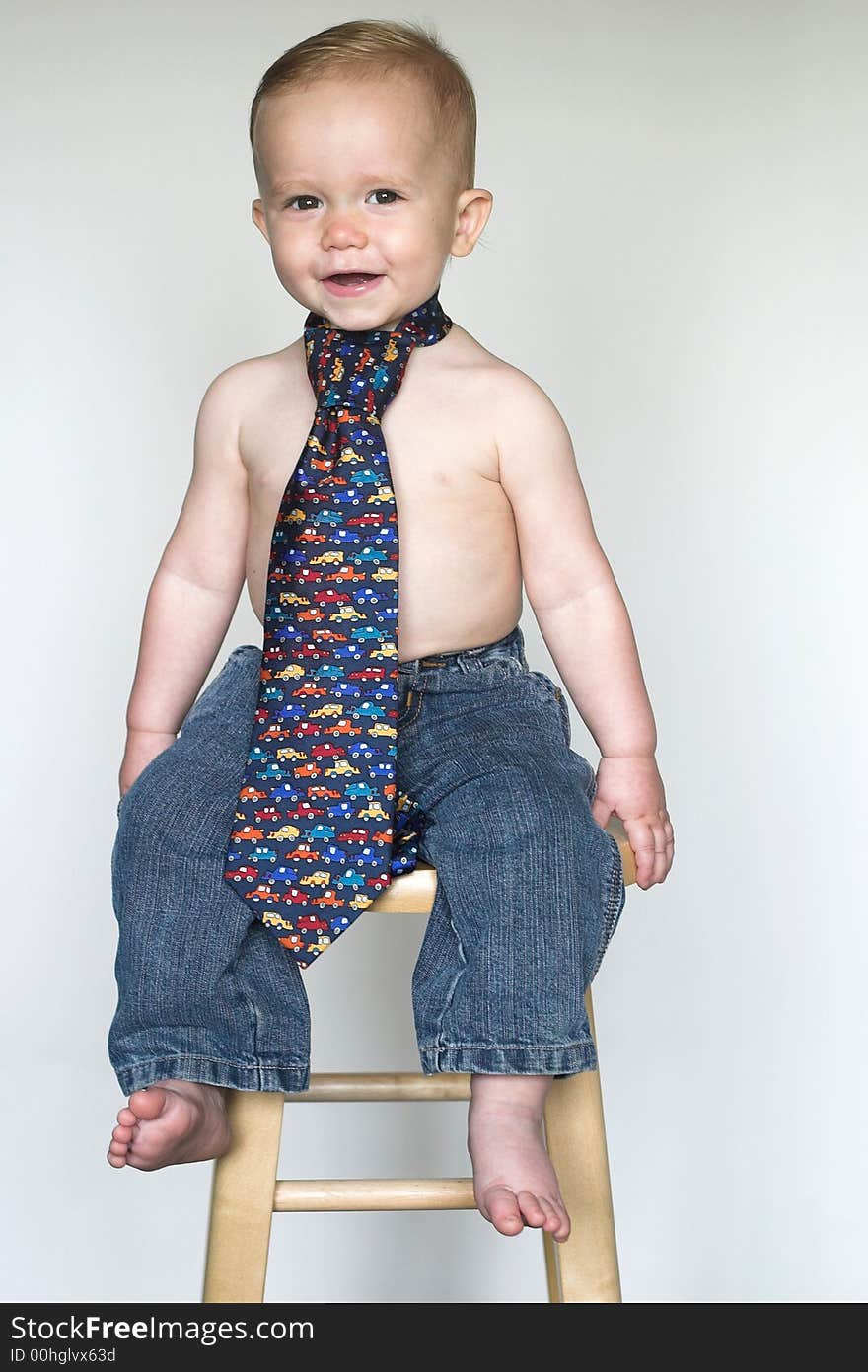 Image of cute toddler wearing jeans and a tie. Image of cute toddler wearing jeans and a tie