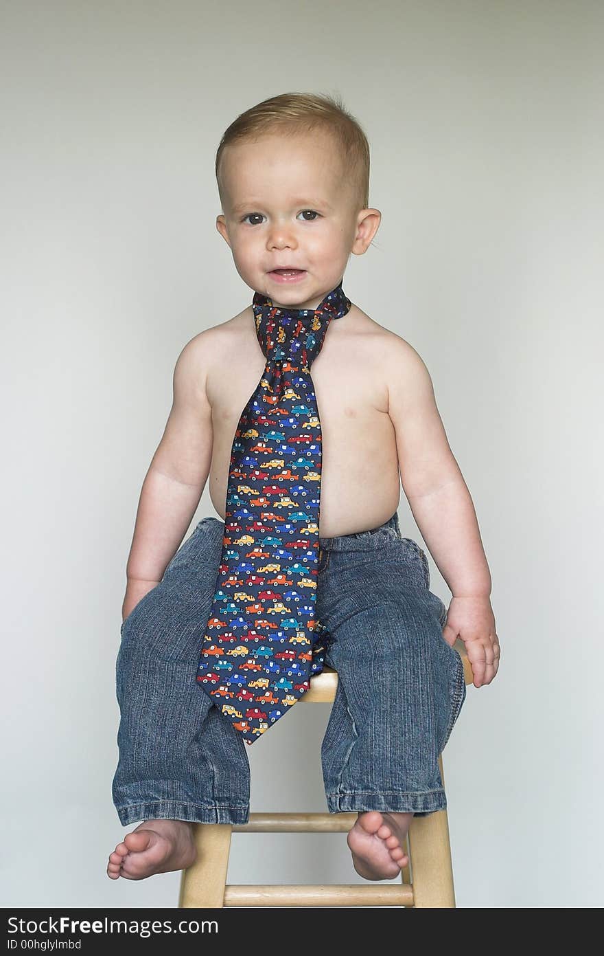 Image of cute toddler wearing jeans and a tie. Image of cute toddler wearing jeans and a tie