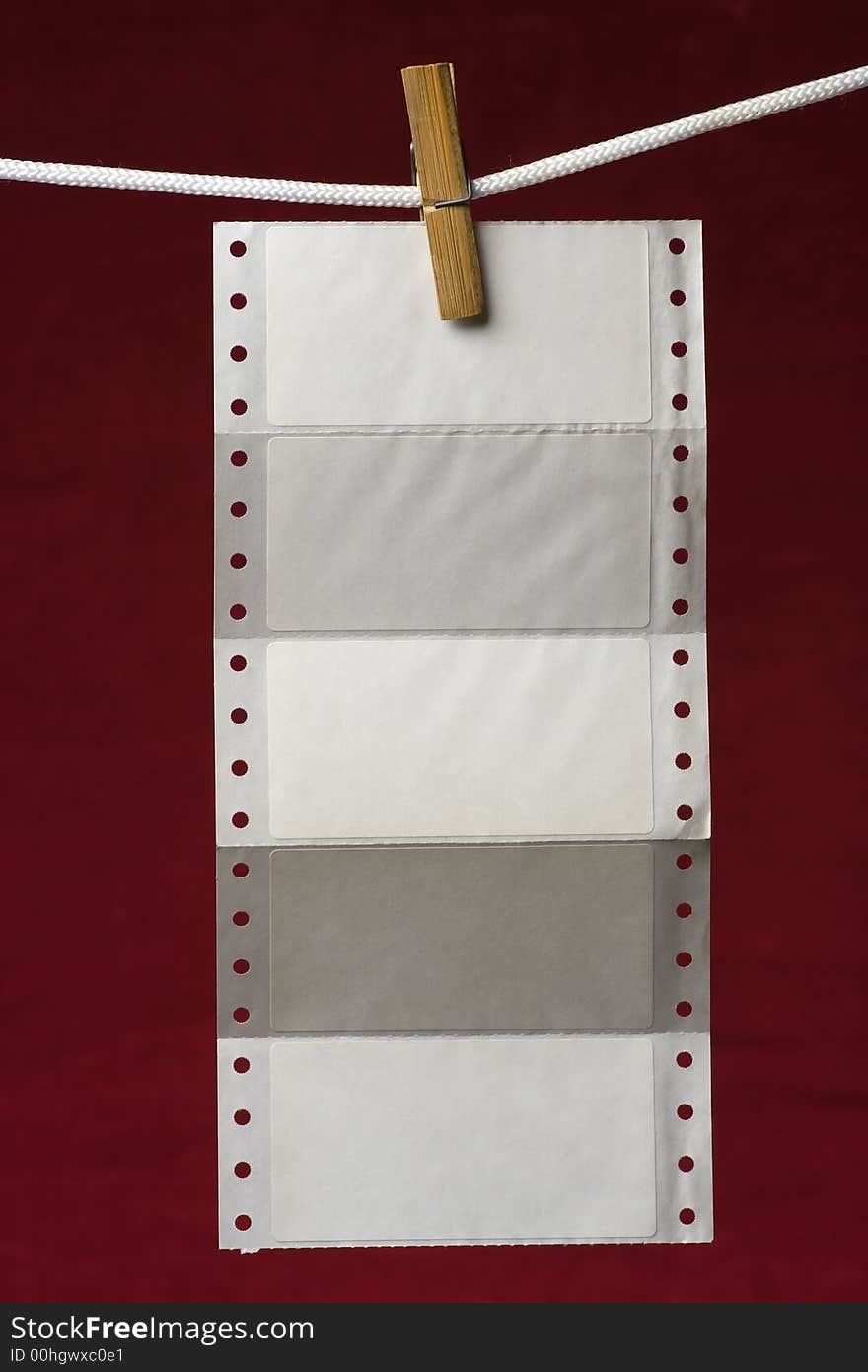 Perforation paper attach clothes-peg to rope on venous background