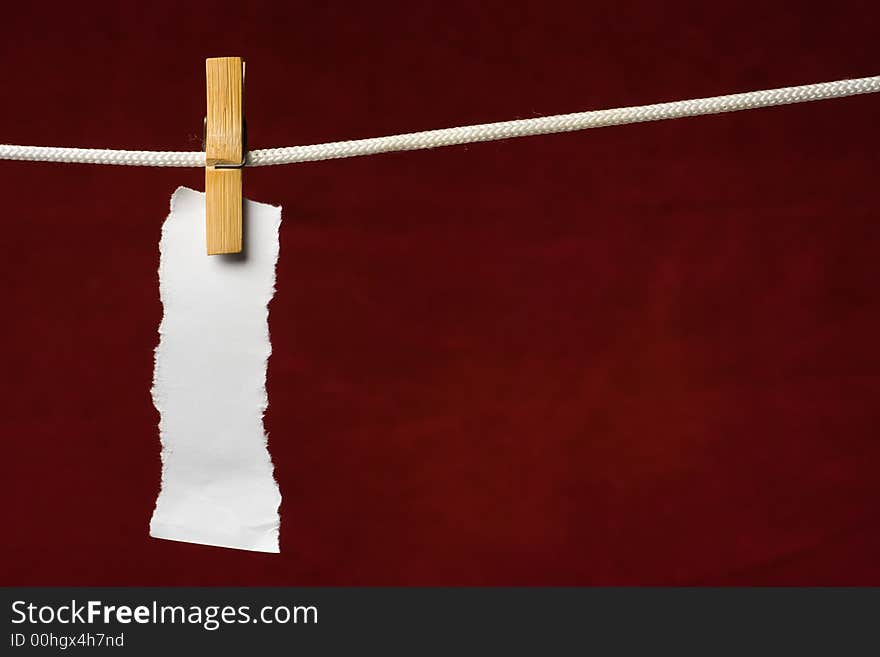 Scrap paper attach clothes-peg to rope on venous background