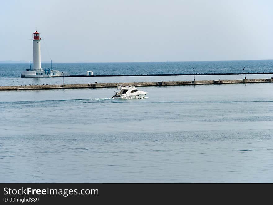 Modern boat go to sea near lighthouse