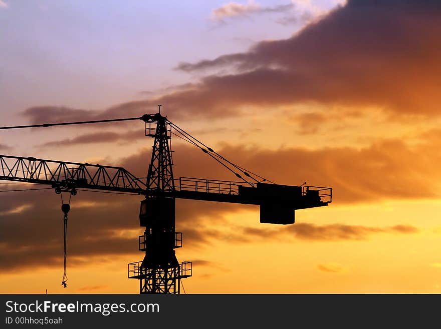 Beautiful sky and silhouette of crane at sunrise in city. Beautiful sky and silhouette of crane at sunrise in city.