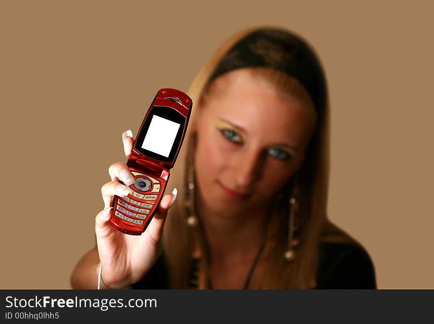 Young beautiful  blond girl with mobile phone, focus on telephone