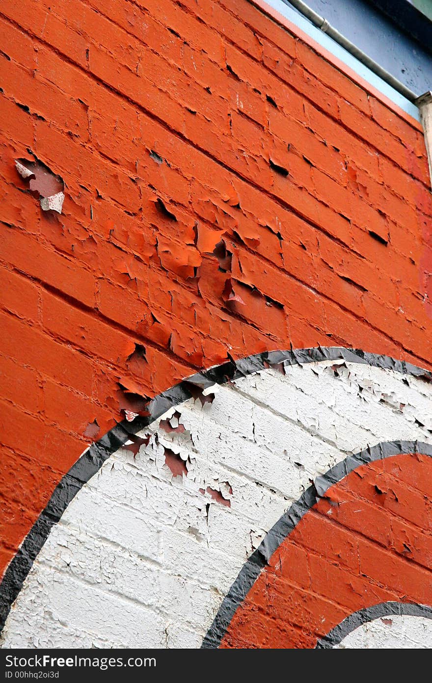 An peeling advertisement painted on a brick wall. An peeling advertisement painted on a brick wall