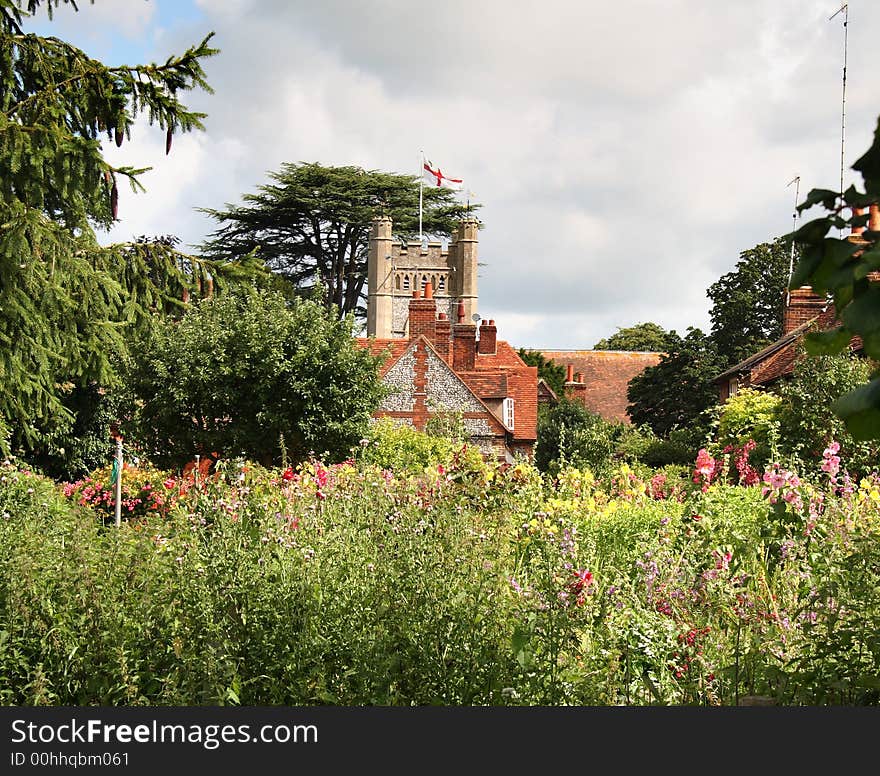 English Village Church viewed from a flower filled Cottage Garden