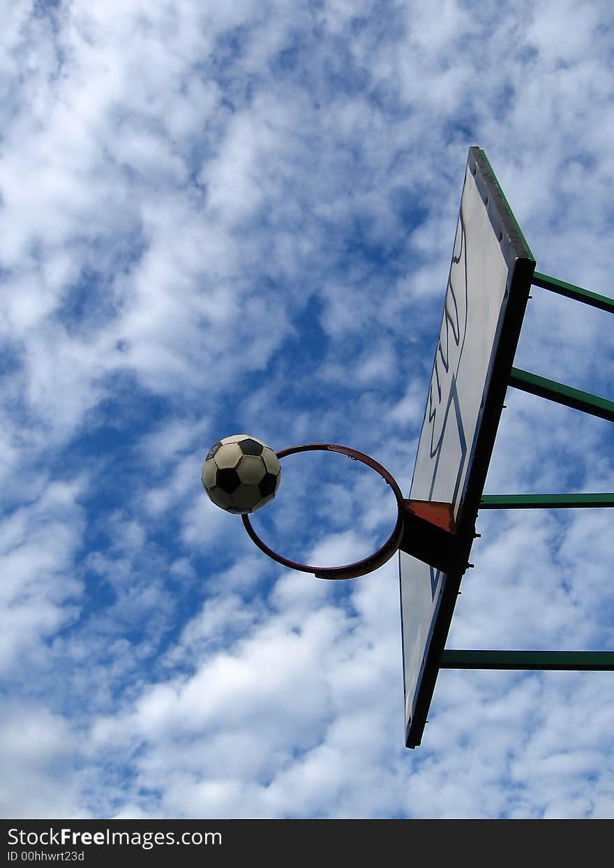 Outdoor basketball,
lovely cloudy background,
football in air,