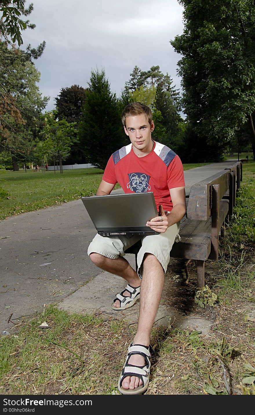 Picture of young man with notebook in park