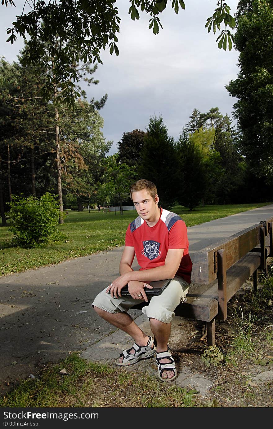 Picture of young man with notebook in park