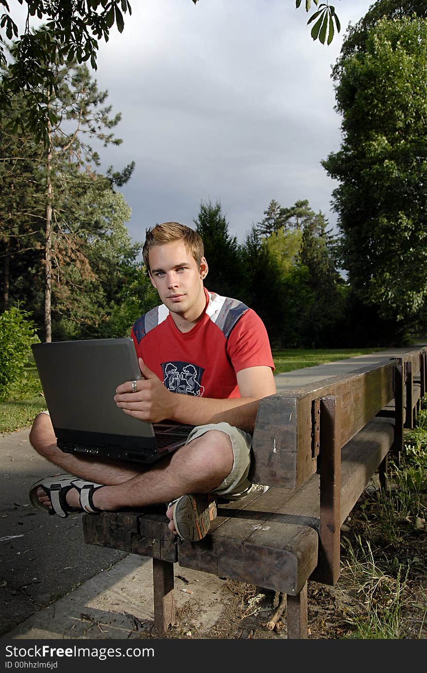 Picture of young man with notebook in park