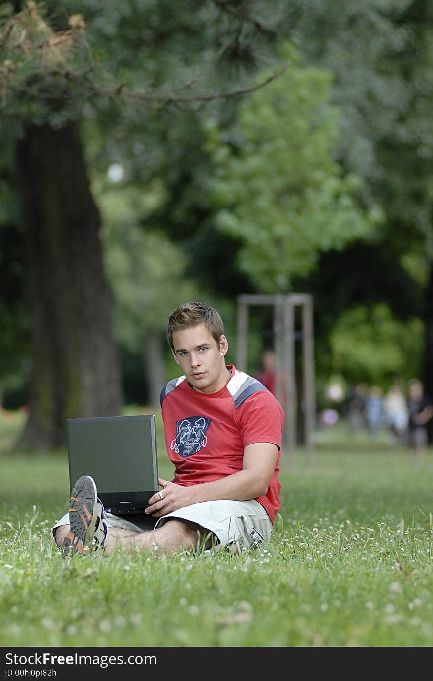 Picture of young man with notebook in park