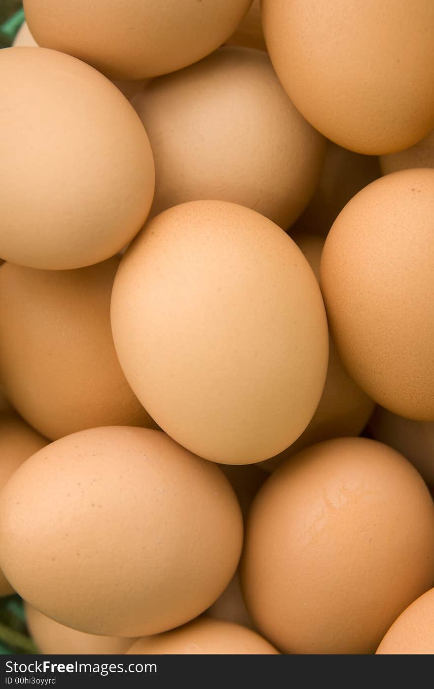 A basket full of brown eggs on a farm. A basket full of brown eggs on a farm