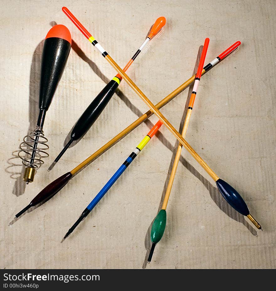 Multi-coloured fishing floats are spread out on a table