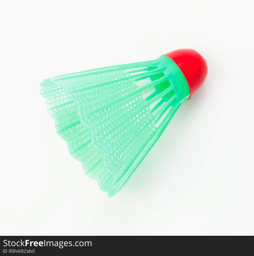 A green badminton ball on white surface. A green badminton ball on white surface