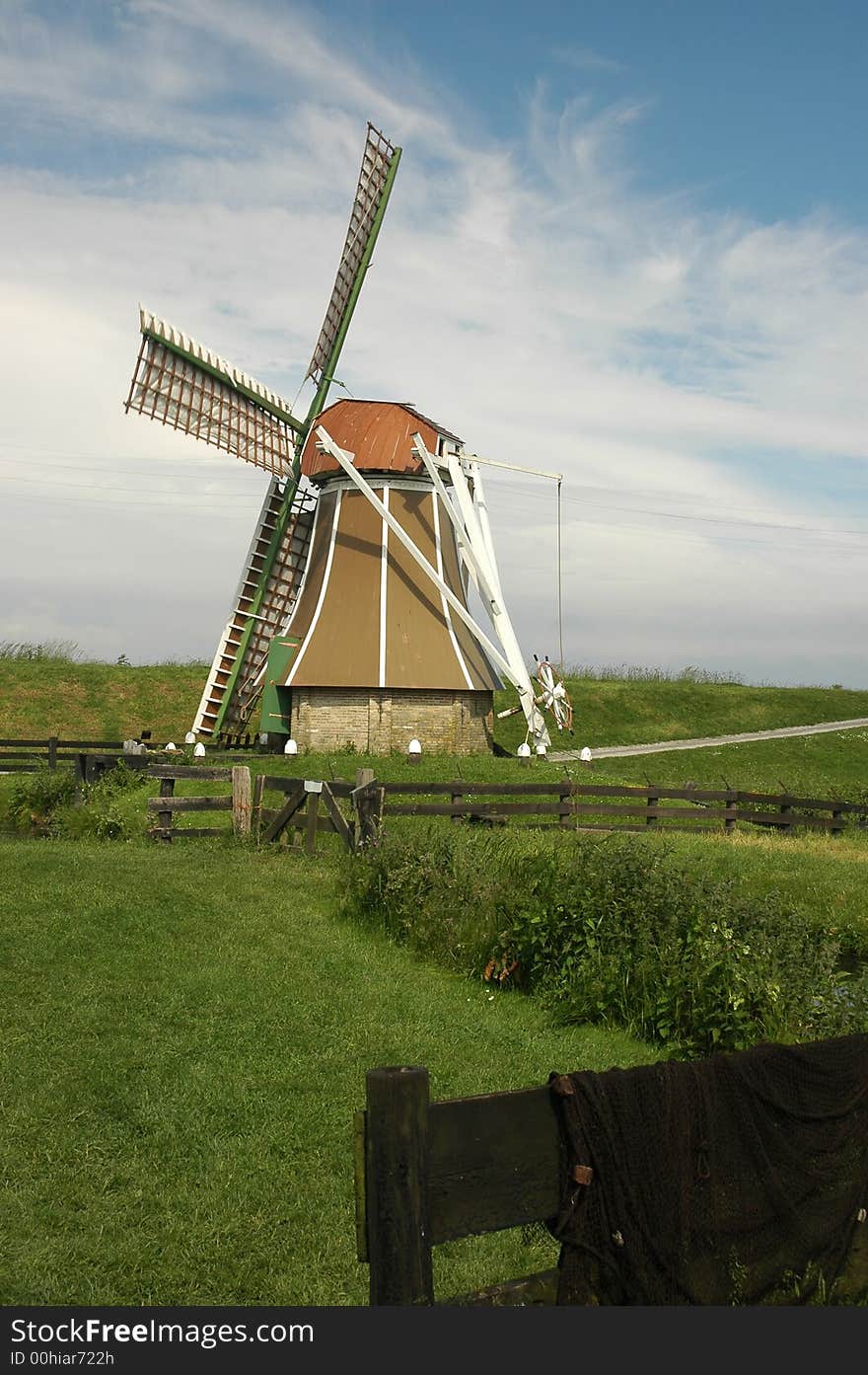 A small windmill near the the IJselmeer in the Netherlands. A small windmill near the the IJselmeer in the Netherlands.