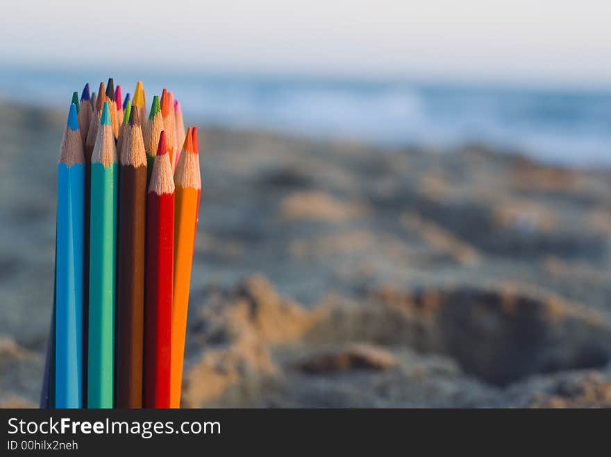 Color pencils in the sand. Color pencils in the sand.