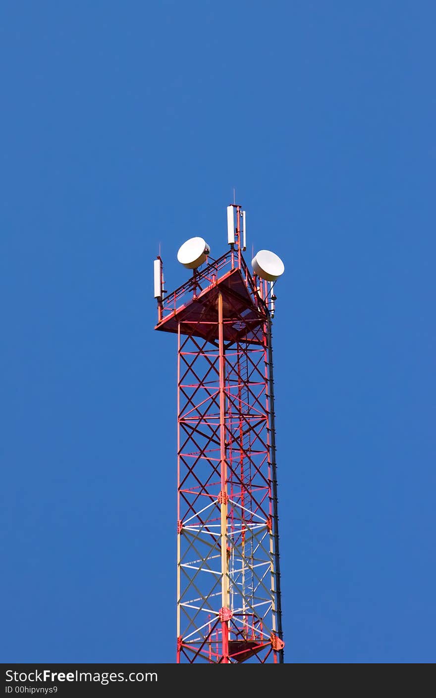 Tower of cellular communication on a background of the blue sky. Tower of cellular communication on a background of the blue sky