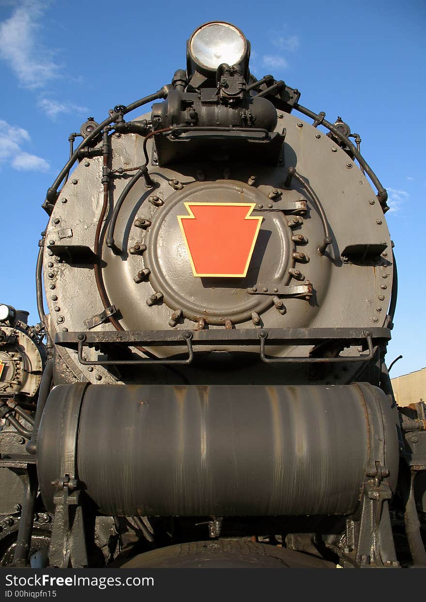 Photo of steam engine in a train yard. Photo of steam engine in a train yard.