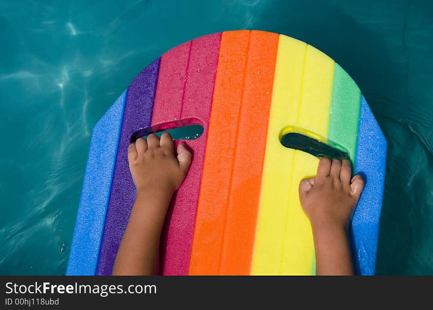 Child's hands on rainbow air-bed. Child's hands on rainbow air-bed