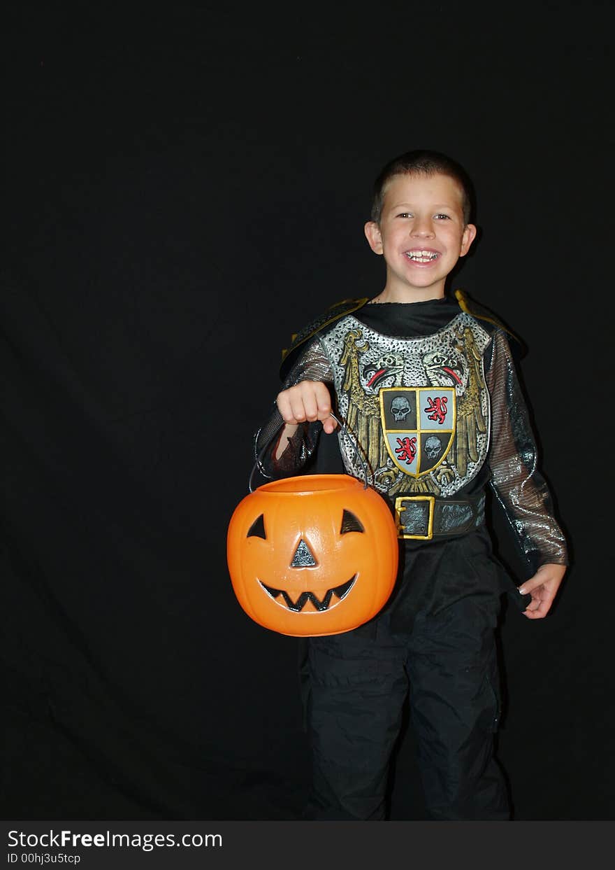 A little boy in a Halloween costume trick or teats