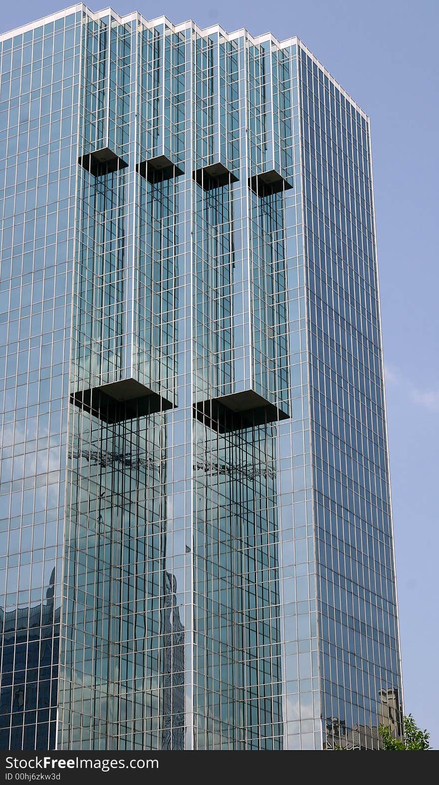 A modern glass office building against the sky. A modern glass office building against the sky