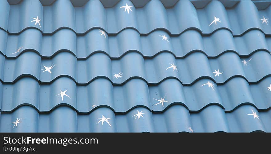 A blue tile roof painted with white stars. A blue tile roof painted with white stars