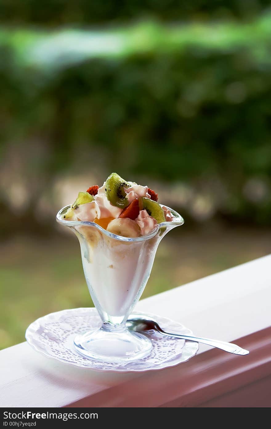 Ice-cream with a banana, a strawberry and kiwi