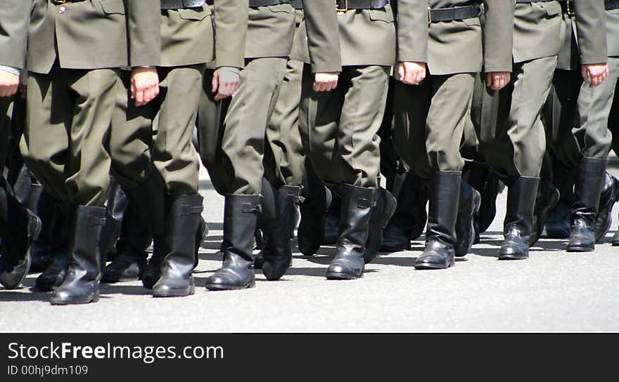 The division of militarians passes a march along the street. The division of militarians passes a march along the street