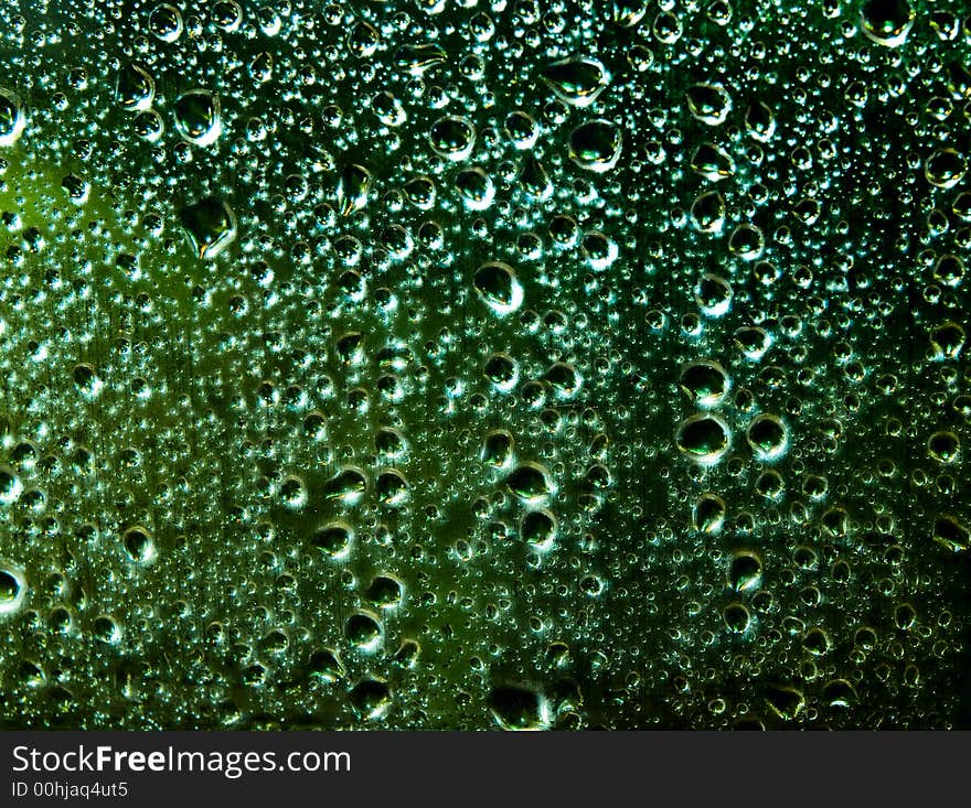 Raindrops over window glass closeup. blurred night background with coloured lights. Raindrops over window glass closeup. blurred night background with coloured lights