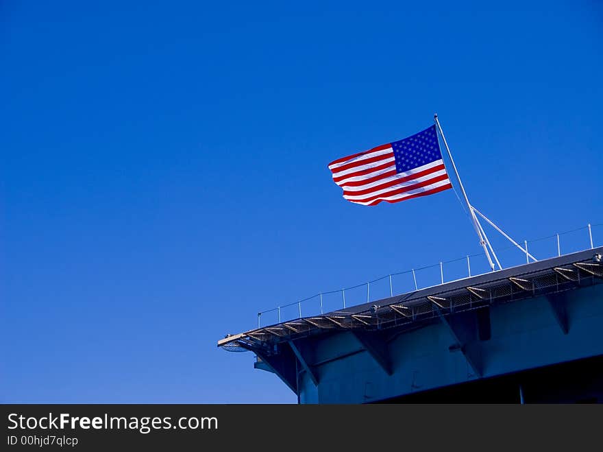 The American Flag on the stern of the aircraft carrier USS Abraham Lincoln docked at the Port of Everett, WA. The American Flag on the stern of the aircraft carrier USS Abraham Lincoln docked at the Port of Everett, WA