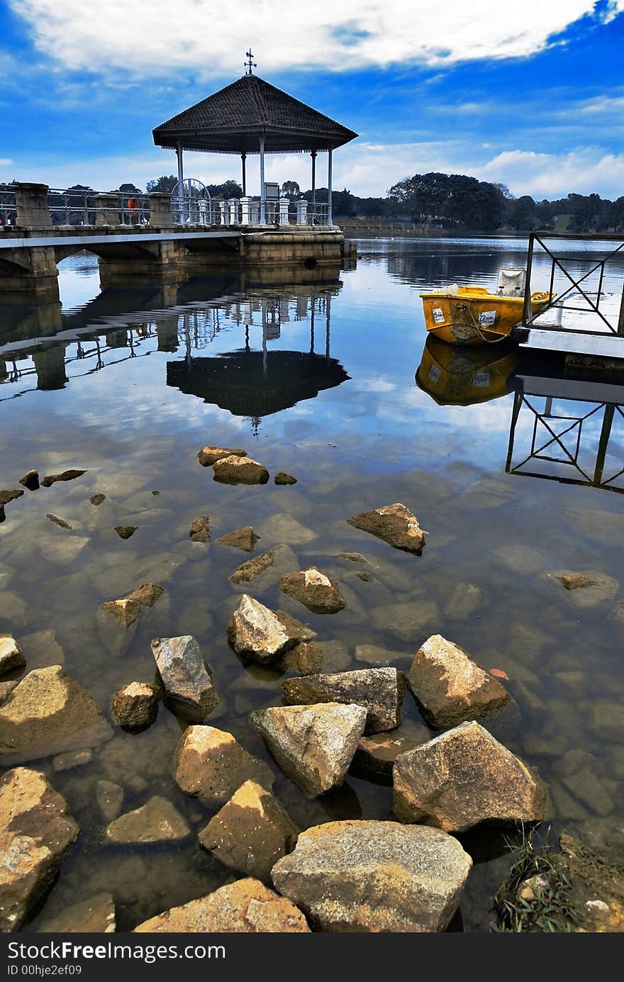 An image of reflections, calm water and blue sky. An image of reflections, calm water and blue sky.