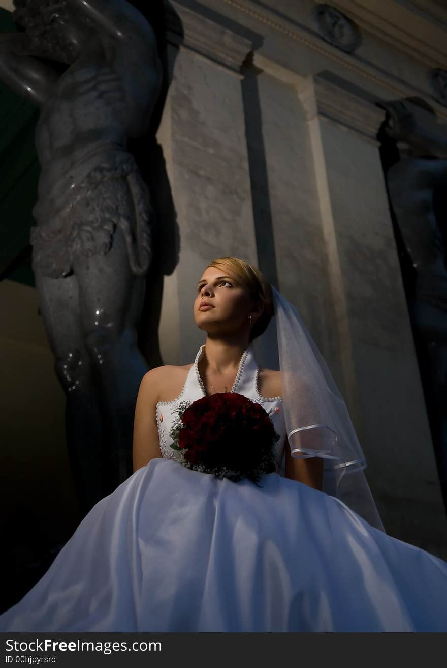 Bride with a bouquet of red roses