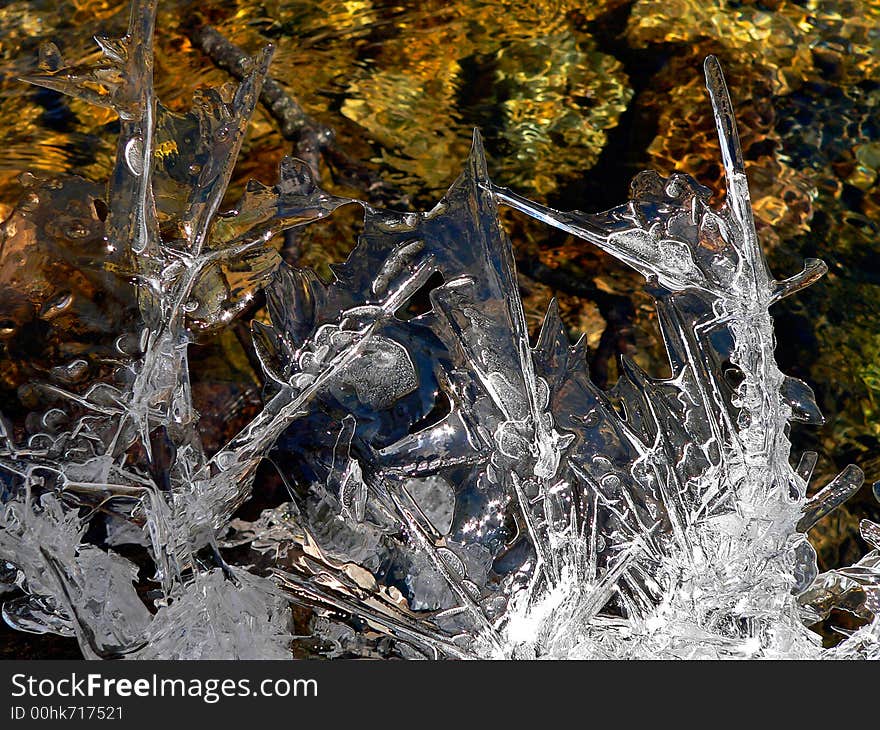 A close up of the fancy melting ice abobe the flowing water. A close up of the fancy melting ice abobe the flowing water.