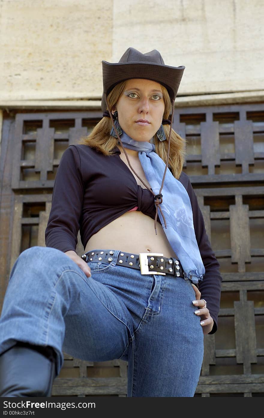 Classy blond woman hiding herself behind a black hat. Classy blond woman hiding herself behind a black hat.