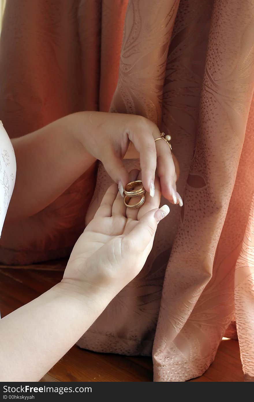 The bride pensively considers wedding rings. The bride pensively considers wedding rings