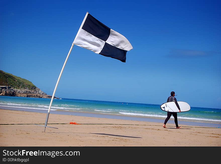 A surfer and surf area flag. A surfer and surf area flag.