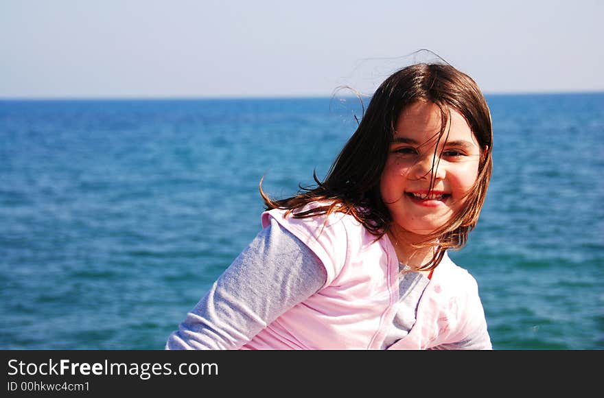 Happy lady with sea as a background