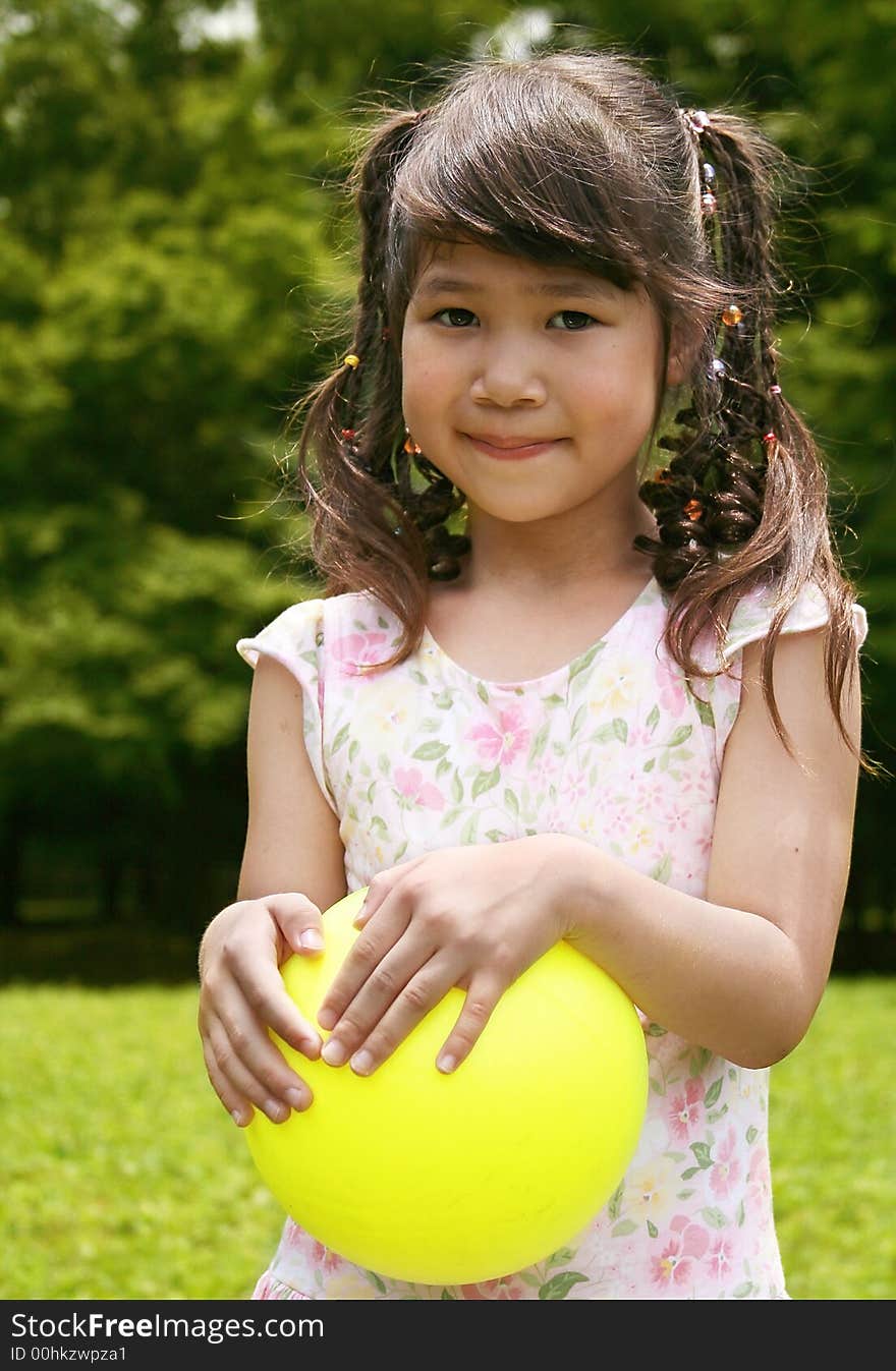 Girl Holding Yellow Ball