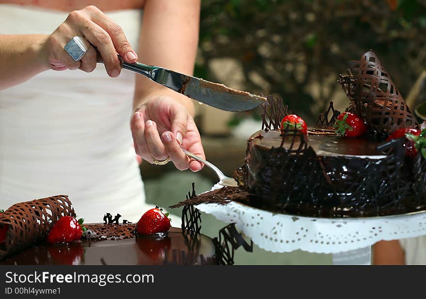 Newly-weds cutting the chocolate pie for celebration