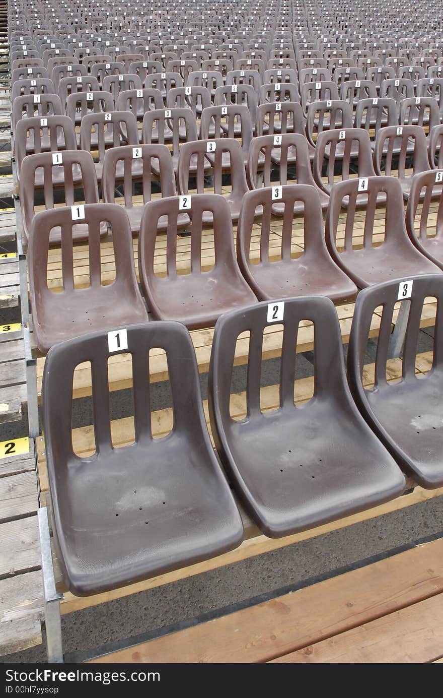 Brown seats in rows for sports/entertainment/concert background use. Brown seats in rows for sports/entertainment/concert background use