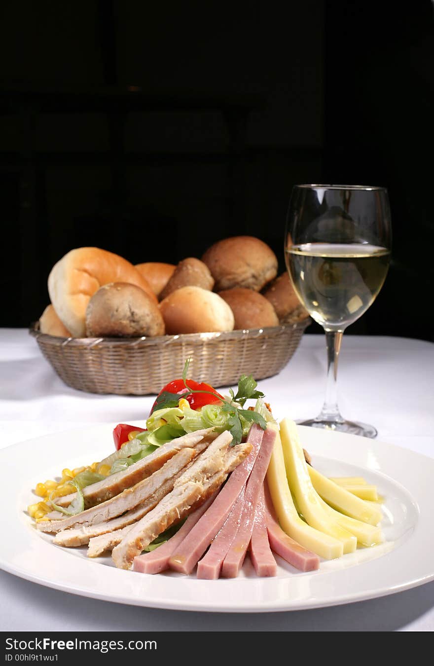 Delicious chicken and ham salad served with bread and white wine, copy space included. Delicious chicken and ham salad served with bread and white wine, copy space included