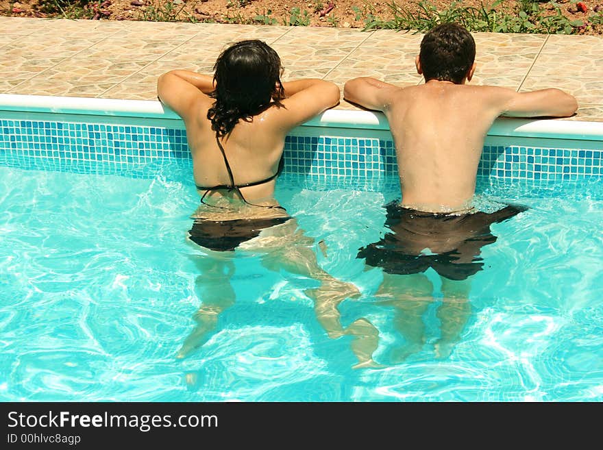 The boy and the girl in the swimming pool.