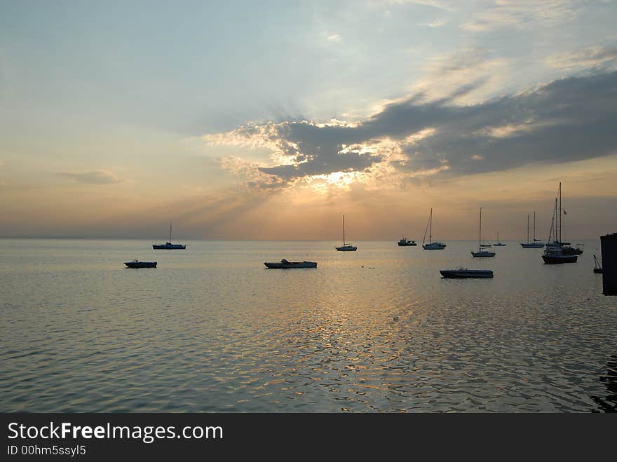 Yachts sitting in sea at sunrise. Yachts sitting in sea at sunrise