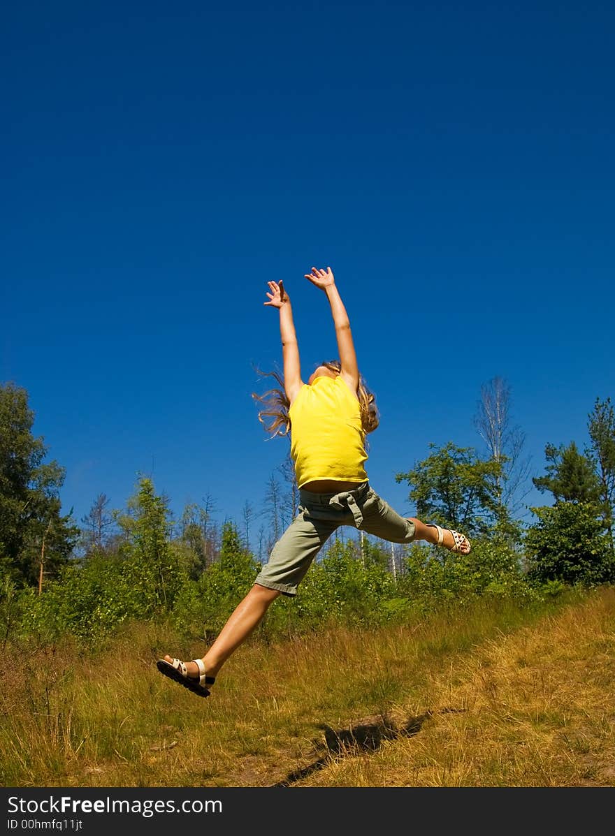 Picture of a Girl jumping on a meadow