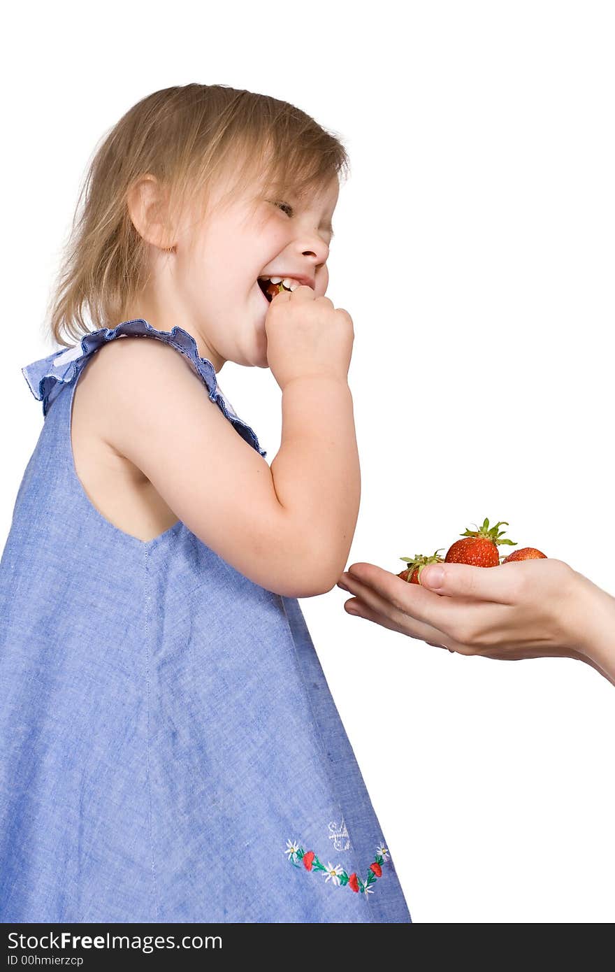 The girl eats a strawberry on an isolated background